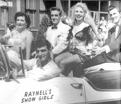 Carnivals often supplied parade units from the back-end shows, for various parades promoting the fair or a still date. Here Mitzi (second from right) beams for the crowds to promote Raynell's 1955 revue on Cetlin and Wilson. To her right is Junior Aldrich and his wife, Gloria, of the acrobatic comedy dance team Kaye and Aldrich. (p. 188)