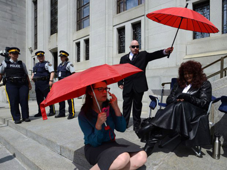 Dominatrix Terri-Jean Bedford (right) sits on the front steps to the Supreme Court of Canada in Ottawa on Thursday, June 13, 2013. The SCOC is hearing arguments on the constitutionality of Canada's prostitution laws. PHOTO: Sean Kilpatrick/The Canadian Press