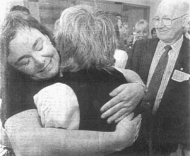 PAYING TRIBUTE: Fiona Stewart of Voce project hugs carol Gardner, Mother of Robin Voce, as father Allan looks on yesterday.