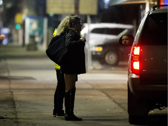 Det. Dan Duiker talks with two women along 118 Avenue, as part of the unit's work conduct welfare checks on sex workers. Photo by David Bloom /Postmedia