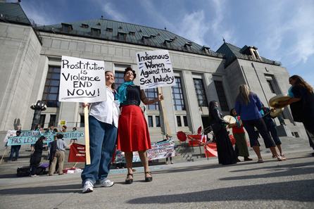 Cherry Smiley, middle right, of Vancouver, B.C., and Sue Martin, left, of Ottawa join others as they rally in front the Supreme Court of Canada in Ottawa on Thursday, June 13, 2013. PHOTO: Sean Kilpatrick/The Canadian Press