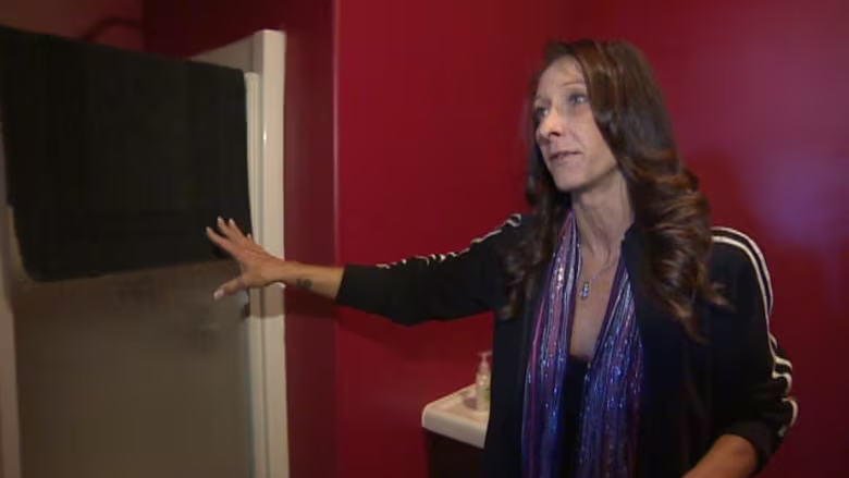 Trish Fisher, operator of The Lion's Den in Saskatoon, points out some of the amenities of the Red Room...