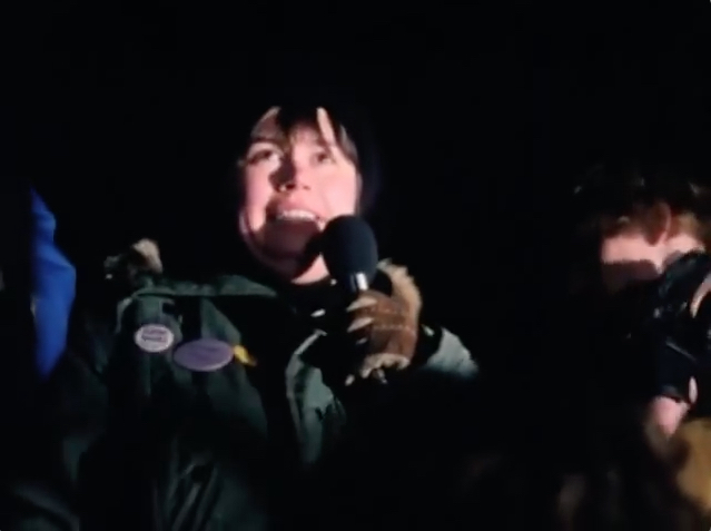 'NO MORE SHIT!' Chris Bearchell speaking at a crowd of 1,000 or more. Toronto, February 6, 1981. Film still courtesy: Nancy Nicol