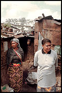 Outside the hovel that is her home in the Pumwani slum of Nairobi, Agnes Munyiva, left, and her friend Salome Kokutona, right, continue to test negative for HIV despite years of prostitution. Karl Vick - The Washington Post